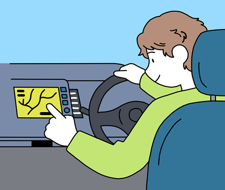 男性が車に乗ってカーナビを操作している